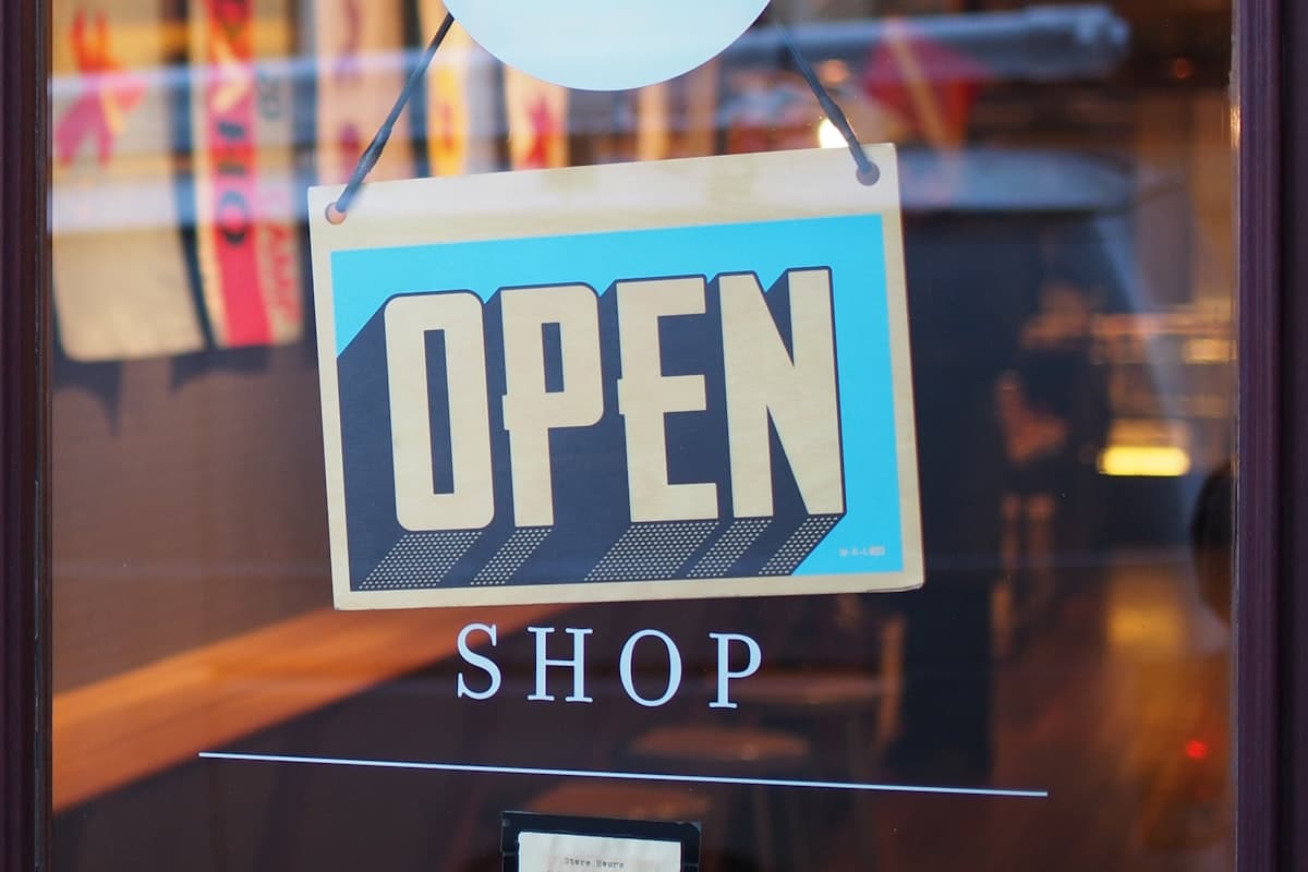 Open sign hanging in a shop window